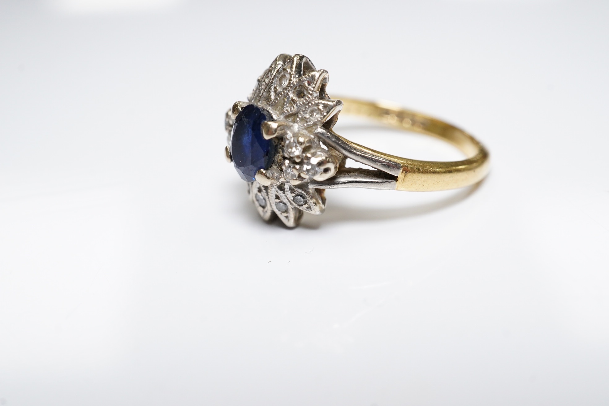 A modern 18ct gold, sapphire and diamond cluster set ring, size M/N, gross weight 4.6 grams. Condition - poor to fair